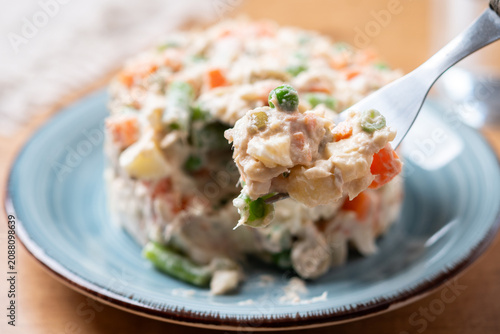 Russian Salad on a Fork on wooden table