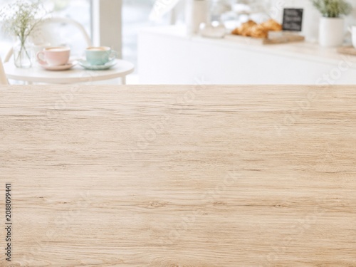 Bright Wooden Tabletop With Blurred Kitchen Background Empty light wood table in a sunlit kitchen, ideal for product display, food styling, home decor, and copy space