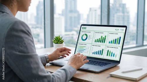Business professional analyzing ESG sustainability metrics on laptop screen