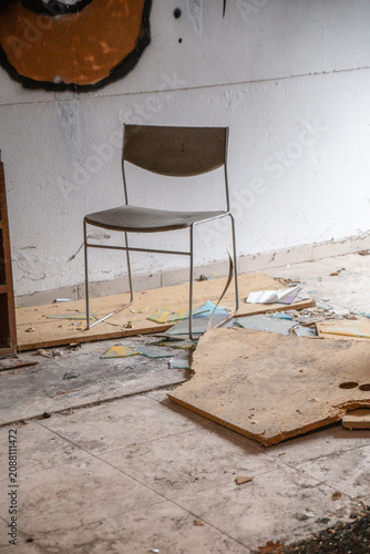 Cuadro en lienzo Abandoned room with dusty chair and broken glass symbolizing dilapidation, decay