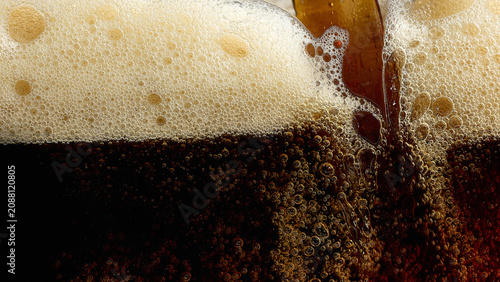 Konstfotografi Dark beer pouring with foam bubbles and amber texture