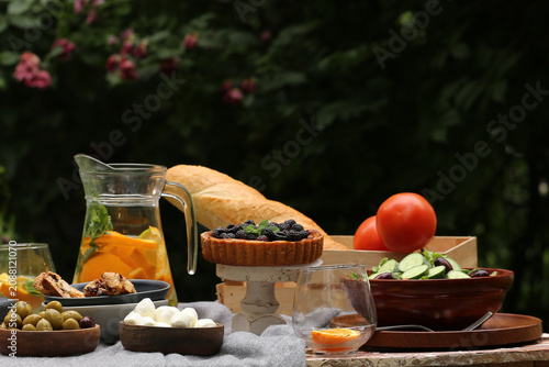outdoor picnic with fresh berries and baked goods
