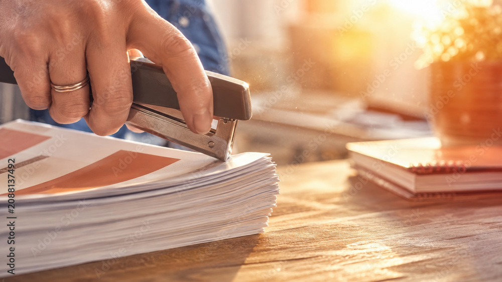 Fototapeta premium Stapler binding a stack of documents