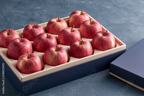 Korean apple gift box for Chuseok holiday, premium fruit gift set side view on dark background
