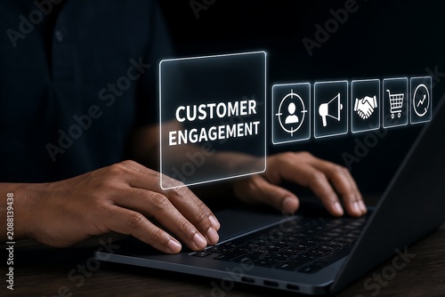 Business professional typing on laptop with customer engagement concept hologram interface