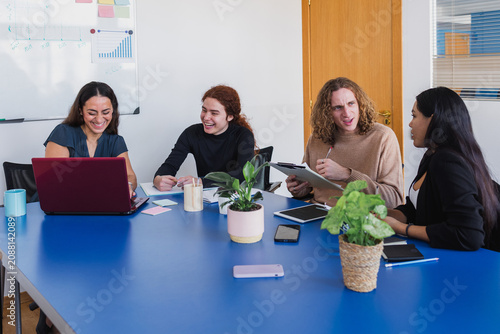 Hispanic Group of young people using laptop and working at office. Diverse latin american teamwork in a meeting together at workplace