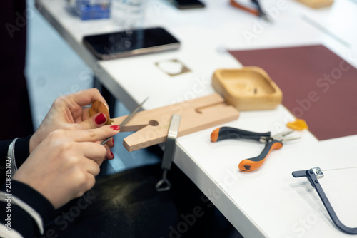 Canvas Print Jewelry artisan filing metal ring on jeweler workbench