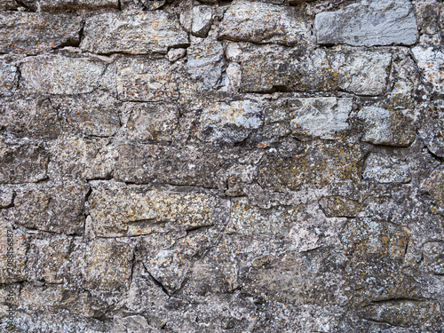 Obraz na plátne Old stone wall with gray and brown tones showing weathered texture and rustic ap