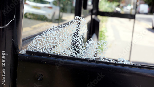 Photos Shattered glass on bus shelter close up, broken window pane from vandalism on ci