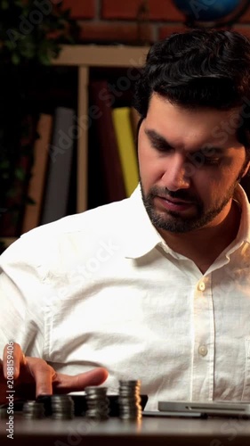 Indian Asian bearded young man working on finances with a laptop, calculator, and documents, ending with tired, sad, or stressed expressions, showing accounting struggles