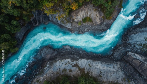 An aerial view of a river running through a lush green forest