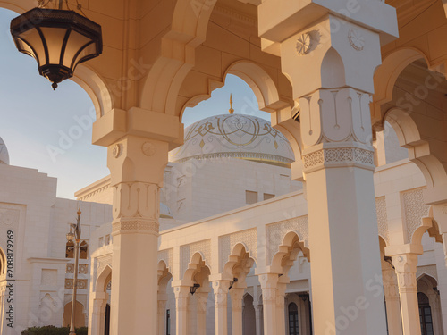 Elegant exterior showcases traditional Arabic design elements with ornate arches and decorative lanterns. White marble walls and geometric patterns create authentic oriental atmosphere