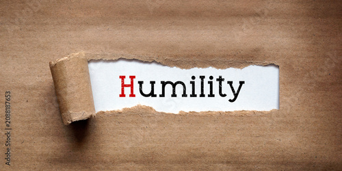 Humility - torn strip of brown kraft paper