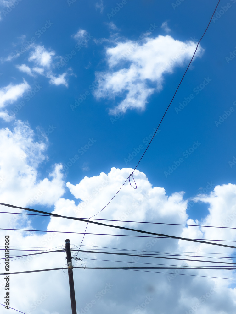 Fototapeta premium Wires Against Blue Sky and Clouds