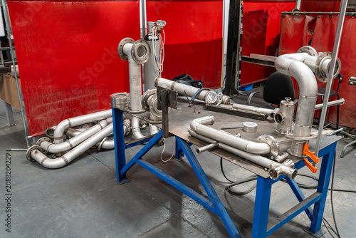 Obraz na plátně Stainless steel pipework assembly on a stand in workshop