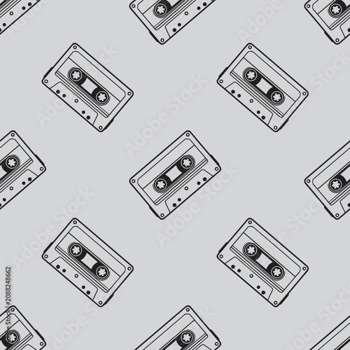 Retro Audio Cassette Tape Seamless Pattern. Vintage monochrome background with classic 90s cassette tapes on a grey backdrop.