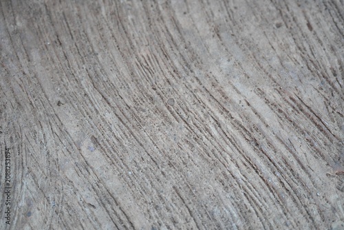 Abstract Texture of Concrete Surface: A close-up view reveals the rugged and textured surface of concrete, with visible lines and variations creating an abstract pattern.