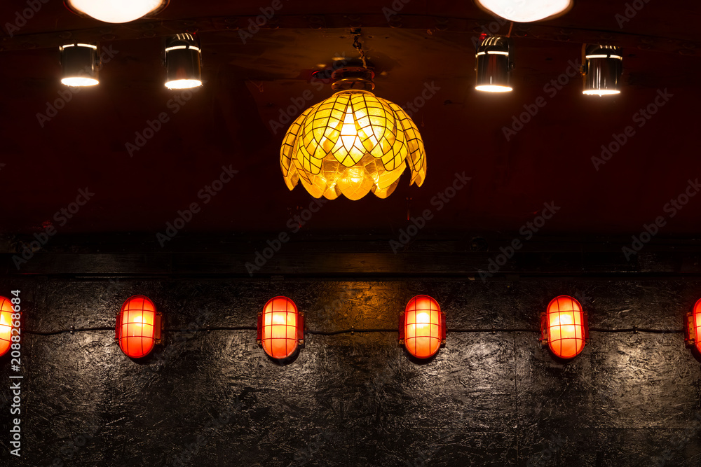 Obraz premium Illuminated lamps creating warm ambiance in dark interior