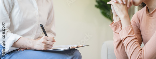 Young woman in a mental therapy session talking with a psychologist in the office.