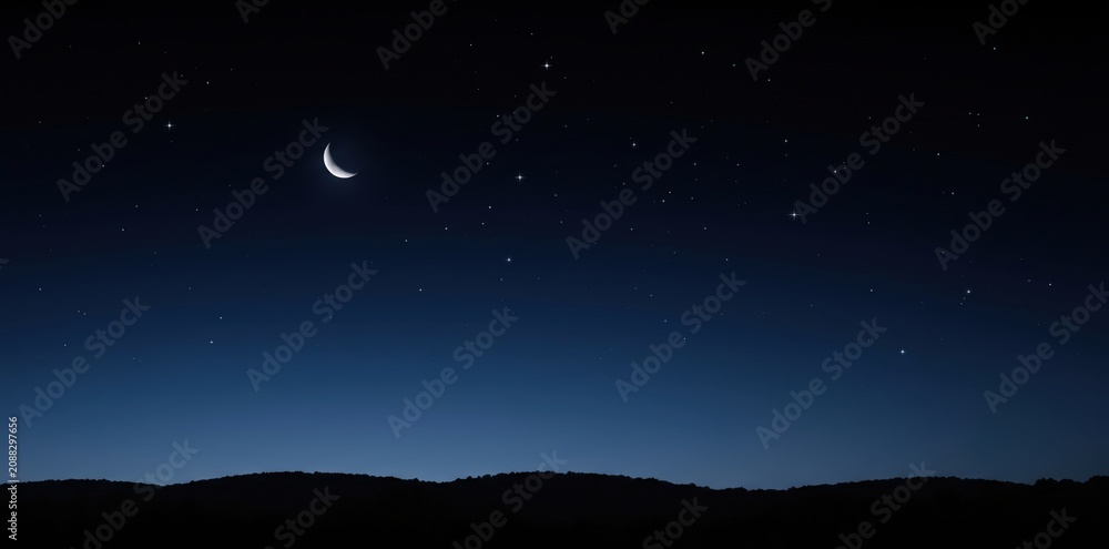 Fototapeta premium A clear dark night sky filled with numerous bright stars and a slender crescent moon hanging above a dark silhouetted rolling landscape of hills