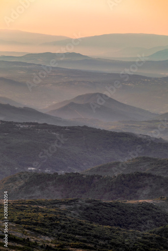 фотографія Vertical view of a sunrise over the Las Batuecas-Sierra de Francia Natural Park, viewed from Peña de Francia, Salamanca, Spain