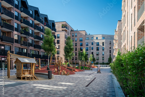 Modern apartment buildings surrounding a public playground