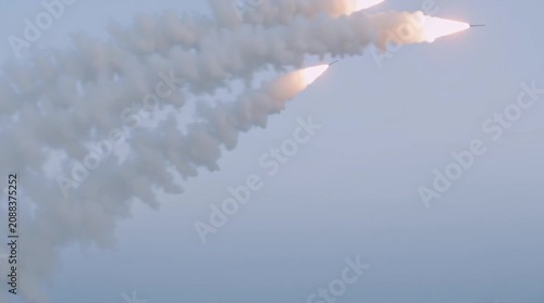 Warship attacks in the open seas by firing a few missiles. Frigate fires rockets in the ocean