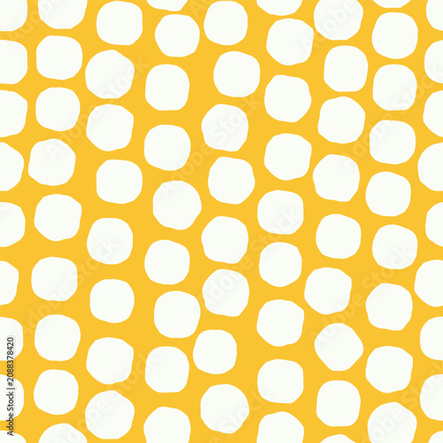 Oversized wonky rounded shapes scatter seamless repeat on a bold ground. Modern Playful Pola Dot Pattern Design with a bold, graphic and naively handcrafted character. Ideal for retro textile