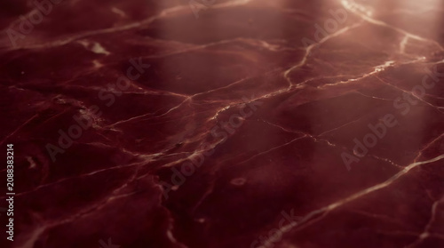 Deep red marble surface with veins and soft lighting texture