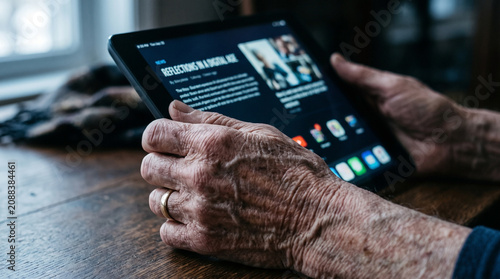 Senior hands using tablet showcasing the silver economy impact