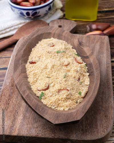 Fafora de pinhão, typical brazilian sidedish on a bowl over wooden table