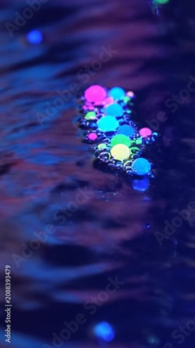 Abstract neon water splash with glowing colorful orbs
