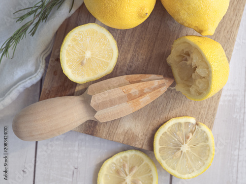 Cuadro en lienzo lemons squeezed with a wooden reamer on a wooden board