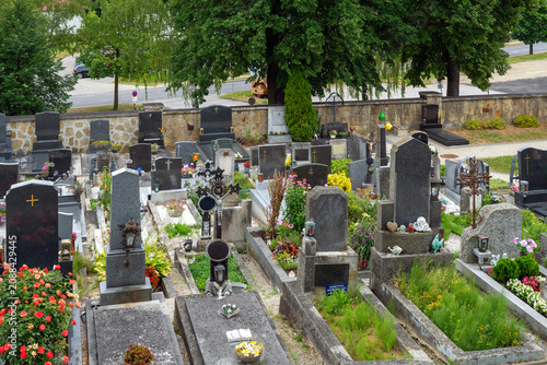 Graves in a small village cemetery in Austria. Names on the headstones have been removed.
