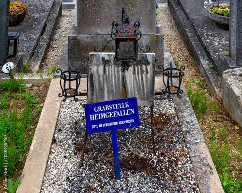 Abandoned, dilapidated, and unmarked old grave plot in an Austrian village cemetery