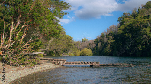 Fotografía Wooden pier on lake shore surrounded by native forest, Patagonia Argentina lands