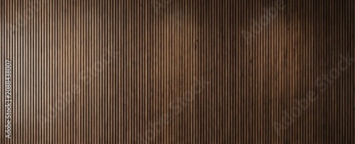 A dark wooden slatted wall background with vertical panels. This texture is ideal for modern interior design and.