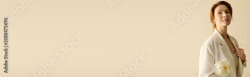 Bild auf Leinwand Elegance shines with a beautiful mature woman wearing stylish attire and holding