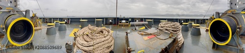 Fotografie Wide panoramic view of a container ship forecastle featuring mooring winches, ro