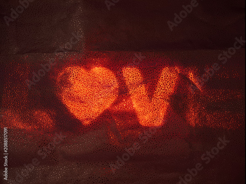 Fotografie Warm light shines through patterns to show a message of love in a dark setting d