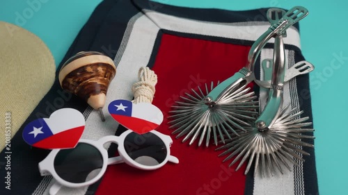 Chilean patriotic items, including spurs, a poncho, and flag-themed glasses, celebrating culture