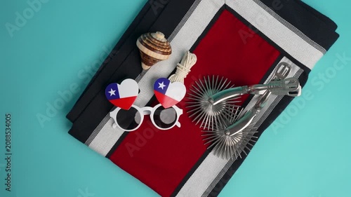 Chilean patriotic items, including spurs, a poncho, and flag-themed glasses, celebrating culture