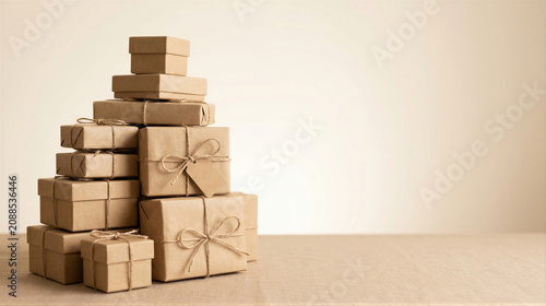 Stack of cardboard gift boxes tied with twine on table. Delivery parcel and brown paper package for holiday sale. Online shopping concept and shipping container for shipping product.