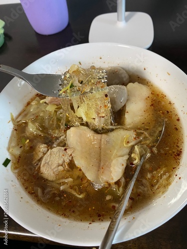 noodle soup. Thai noodle soup. Thai food. Asian food. Braised beef. Frish meatballs. Noodles. Hot broth. Chopsticks. Homemade food. Bowl of noodles. Comfort food.