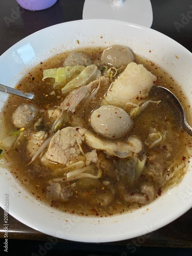 noodle soup. Thai noodle soup. Thai food. Asian food. Braised beef. Frish meatballs. Noodles. Hot broth. Chopsticks. Homemade food. Bowl of noodles. Comfort food.