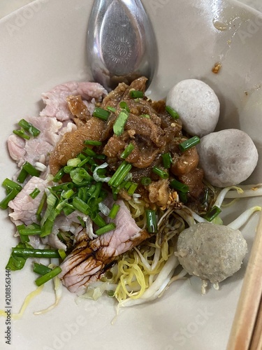 Beef noodle soup. Thai noodle soup. Thai food. Asian food. Braised beef. Beef meatballs. Noodles. Hot broth. Chopsticks. Homemade food. Bowl of noodles. Comfort food.