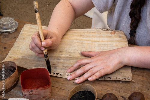Tableau sur toile Barcelona Spain - July 7 2026: Scribe writing ancient document