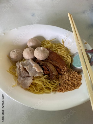 thai noodle soup. egg noodles. beef noodle soup. beef meatballs. braised beef. thai noodles. noodle bowl. asian food. comfort food. street food. homemade food. food photography. hot soup. savory meal.