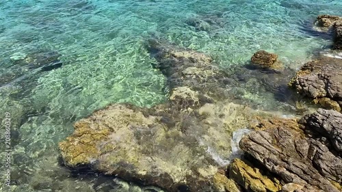 Clear water over rocks with sun shining in the afternoon at a coastal area