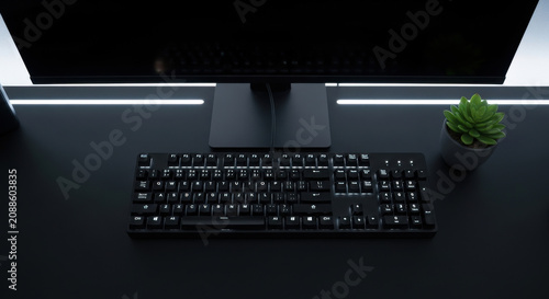 Minimalist Dark Desk Setup With Illuminated Keyboard And Monitor